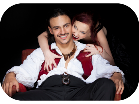 a vampire couple with female vampire about to bite the man